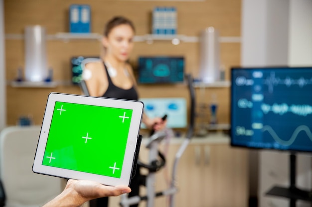 Doctor holding a digital tablet PC with chroma mock up on it