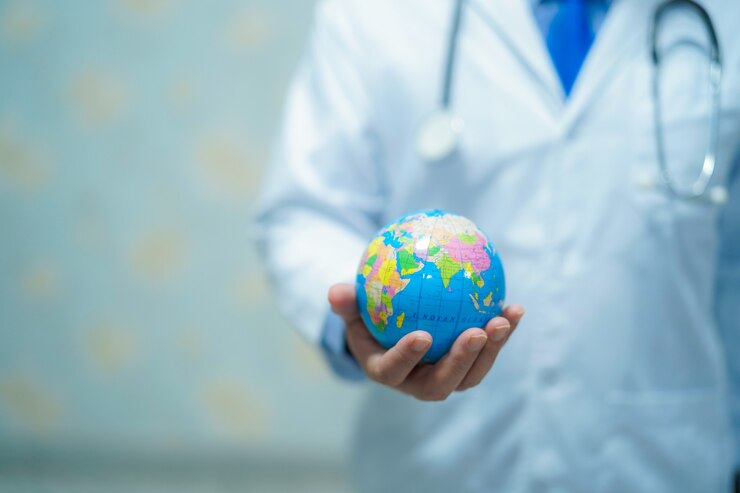 Photo doctor holding a globe