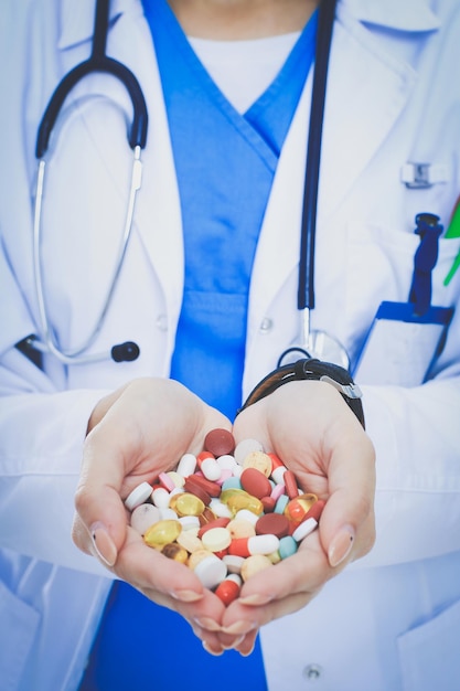 Doctor holding heap of drugs in a hand. Woman doctor