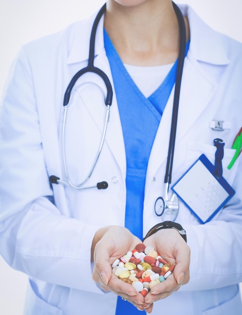 Doctor holding heap of drugs in a hand Woman doctor