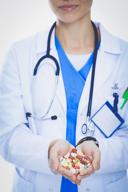 Doctor holding heap of drugs in a hand Woman doctor