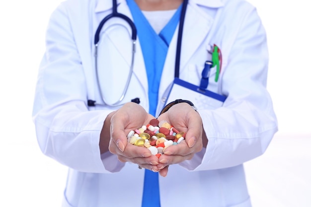 Doctor holding heap of drugs in a hand