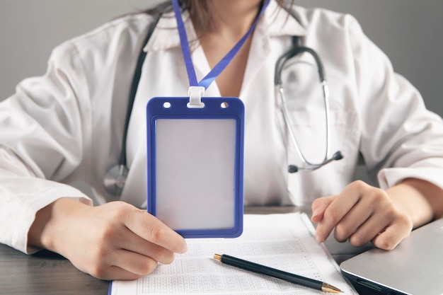 Doctor holding an id tag