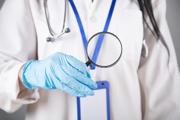 Doctor holding a magnifying glass