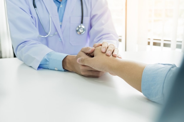 Doctor holding a patient hand