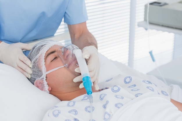 Doctor holding patients oxygen mask