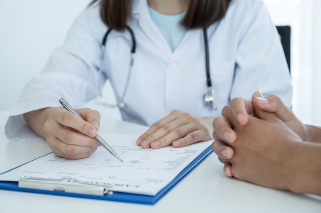 Doctor holding pen, doctor report health examination results and recommend medication to patients.