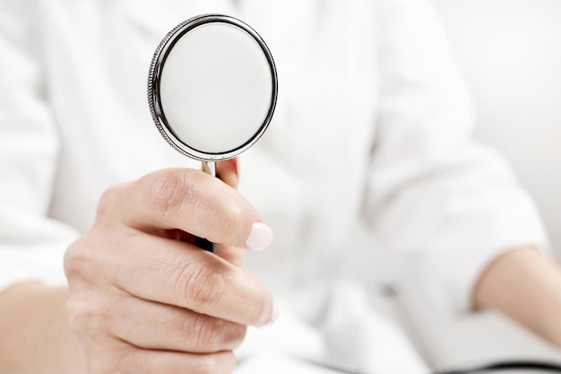 Doctor holding a phonendoscope or stethoscope in his hand