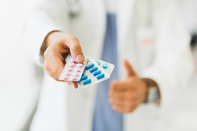 Photo doctor holding pills in hand