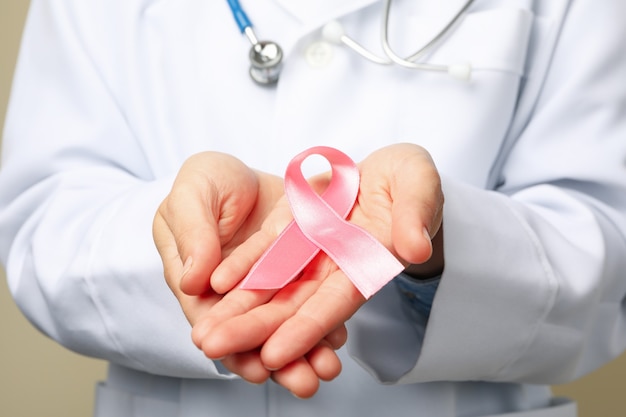 Doctor holding pink awareness ribbon