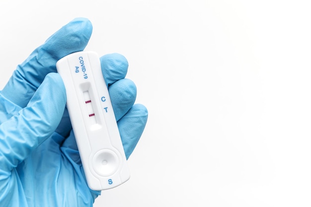 Doctor holding a positive result for COVID19 with test kit for viral disease