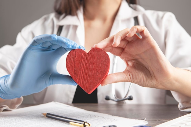 Doctor holding a red heart in his hands