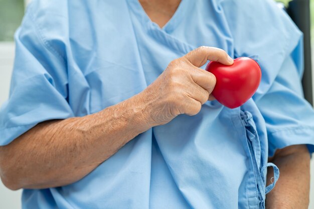 Photo doctor holding a red heart in hospital healthy strong medical concept