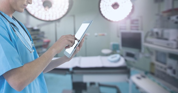 Doctor holding tablet in surgery operating theatre