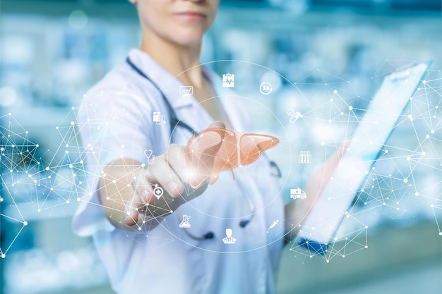 A doctor holding a tablet with the word liver on it