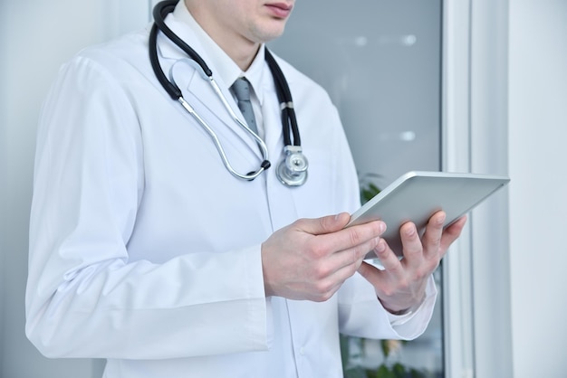 터치 패드 태블릿 컴퓨터를 들고 있는 의사