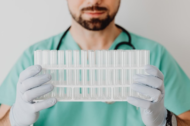 doctor holding tray of test tubes