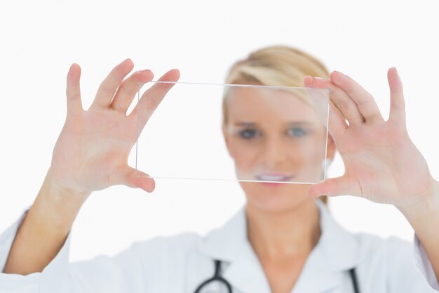 Doctor holding up clear pane