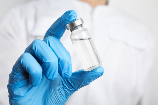 Doctor holding vial with medication closeup Vaccination and immunization