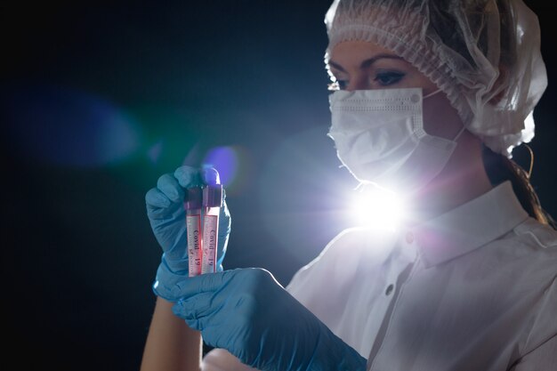 Doctor holding vials with blood