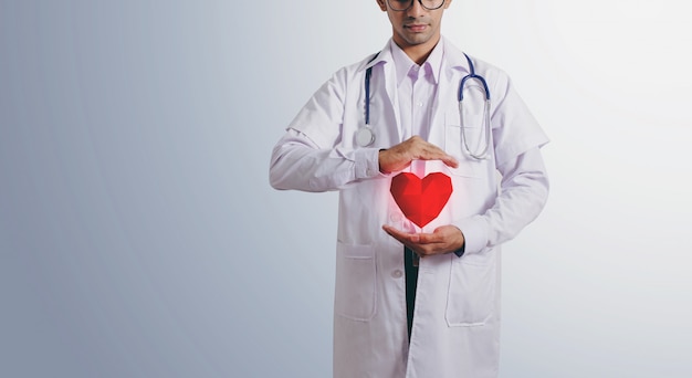 Foto medico che tiene il cuore virtuale