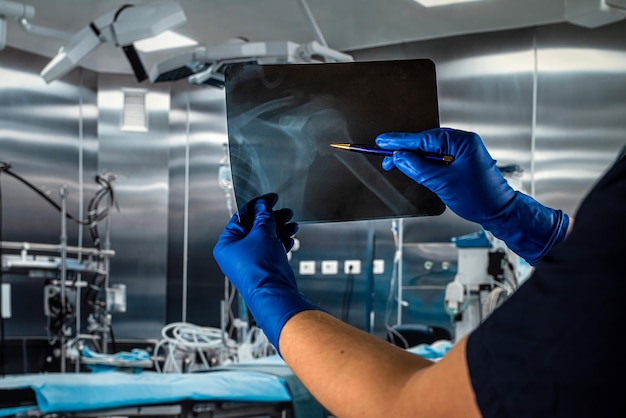 Doctor holding xray image at surgical office at the hospital