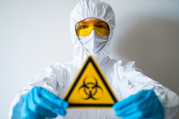 Photo the doctor holds a biohazard sign. quarantine zone, coronavirus pandemic