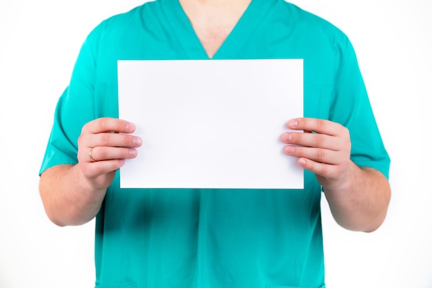 A doctor holds a blank sheet in hands