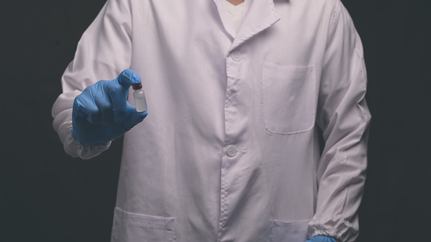 Doctor holds a bottle of vaccine medicine