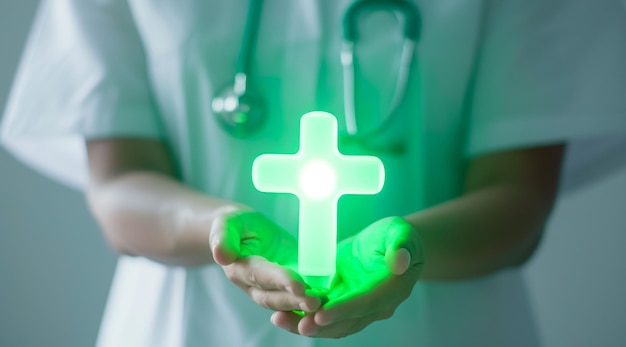 The doctor holds a pictogram of a green cross in his hands The symbol of health