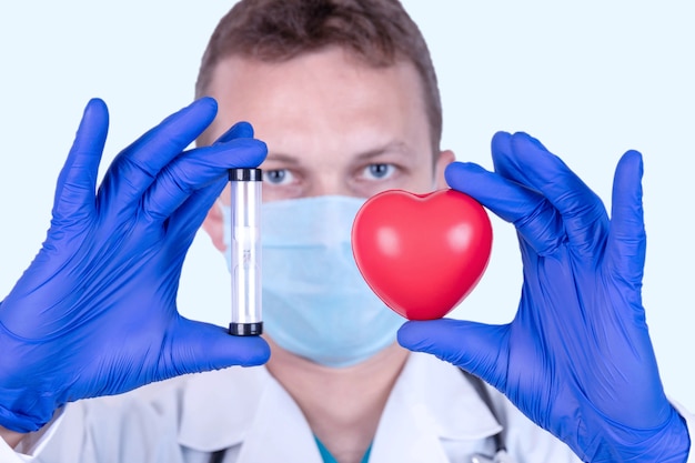 The doctor holds a red heart in front of him as a symbol of health