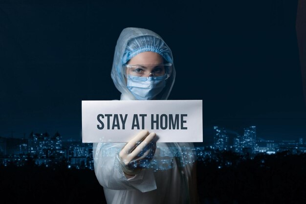 Doctor holds a sign saying stay at home The concept of compliance with quarantine