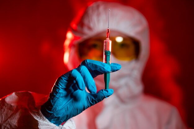 the doctor holds a syringe with medicine. concept - new coronavirus treatment, vaccine