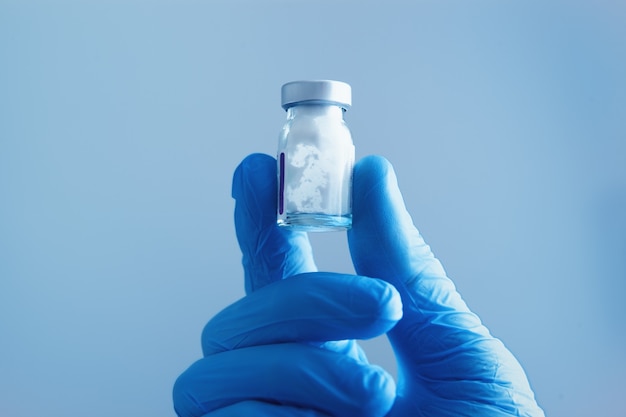 The doctor holds the vaccine for the patient