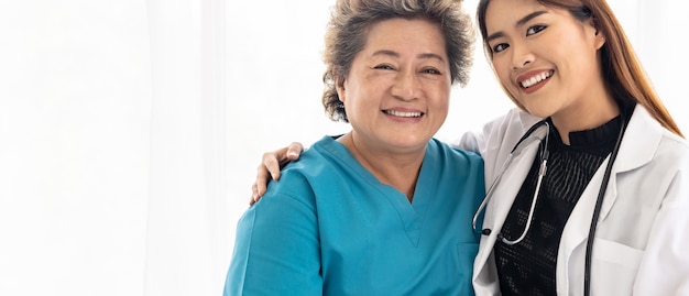 Doctor hugging elderly patient