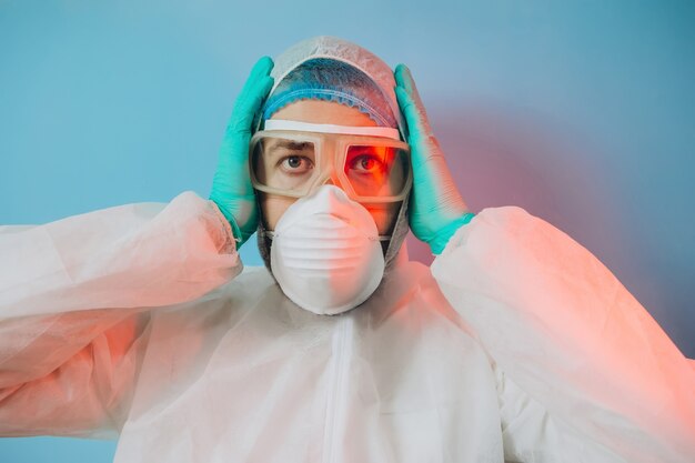 Doctor in de beschermende uniform, reperitor, bril, handschoenen