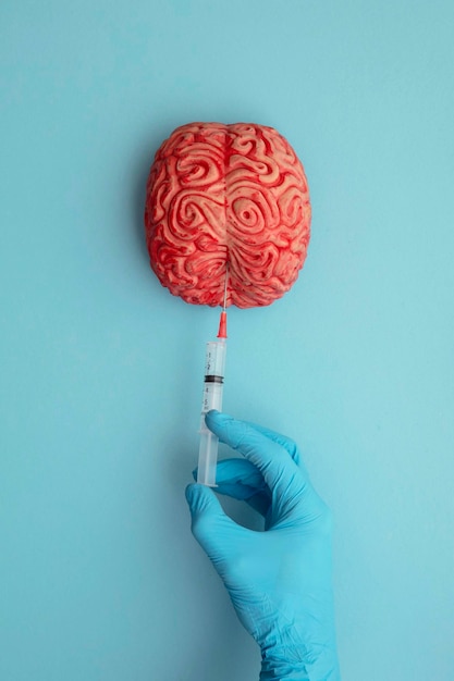 Doctor injecting a brain with a syringe mental illness concept