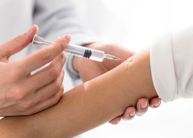 Photo doctor injecting the vaccine in a patient