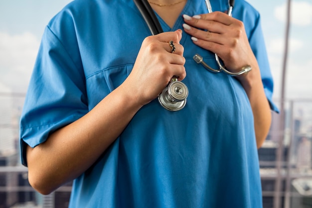 Doctor intern girl in a medical gown with a stethoscope standing in the hospital