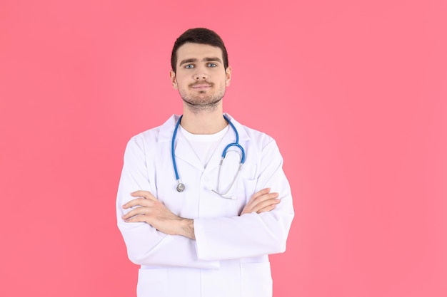 Doctor - intern with stethoscope on pink background