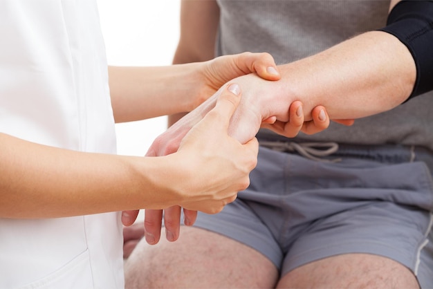 A doctor is checking a patient's hand.