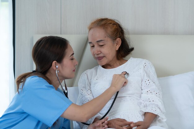 The doctor is doing a preliminary examination to monitor the symptoms of an elderly patient