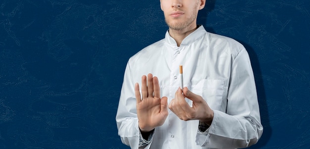 A the doctor is holding and braking the cigarette, quit and stop smoking