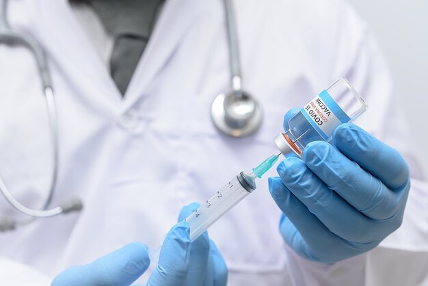 The doctor is preparing the vaccine and Syringe tube to Treatment sick person