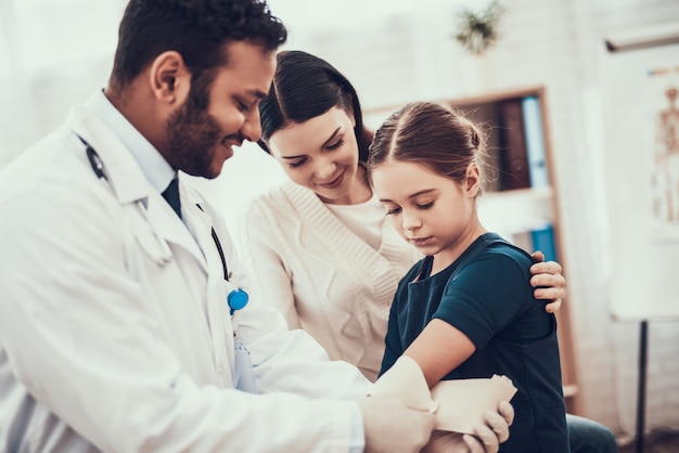 Doctor is using harness on daughter's arm.