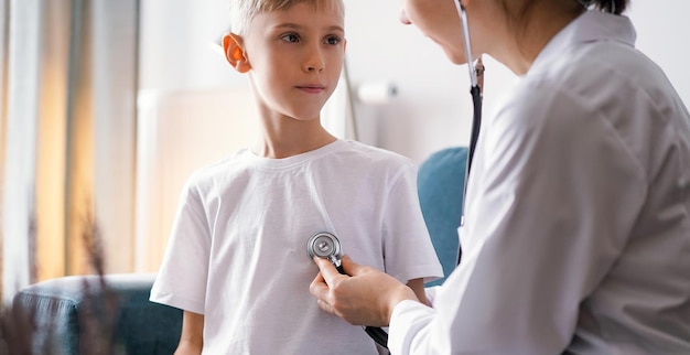 Doctor and kid boy at home. Child patient at usual medical inspection. Medicine, healthcare concepts