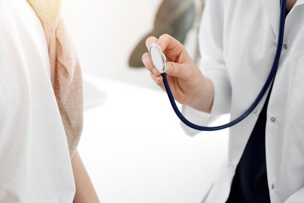 Doctor and a kid patient. physician is holding stethoscope and ready to examine boy. perfect health concept in medicine.