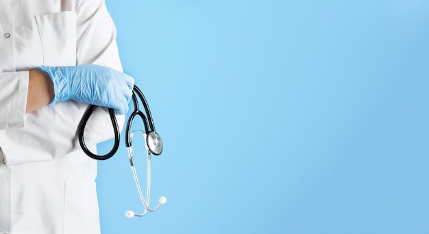 Doctor in a lab coat with stethoscope over blue background