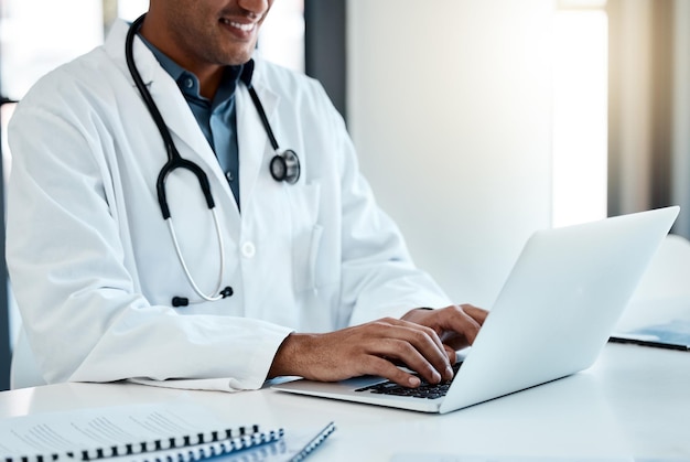 Doctor laptop and typing email or online medical prescription for healthcare treatment plan Hospital clinic and male physician or specialist browsing digital medicine data or information