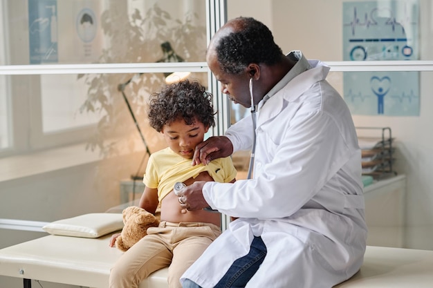 Doctor listening to heartbeat of patient